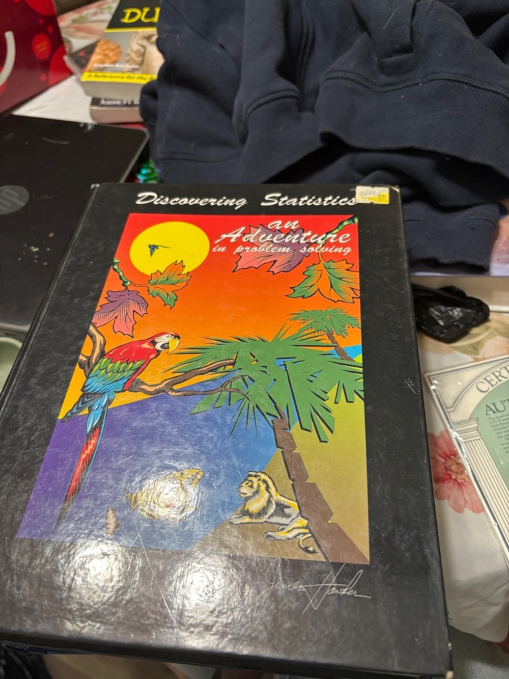 Discovering Statistics textbook with Colorful Parrot Cover